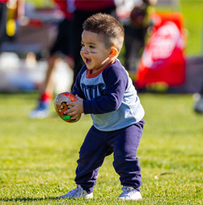 A kid holding a ball